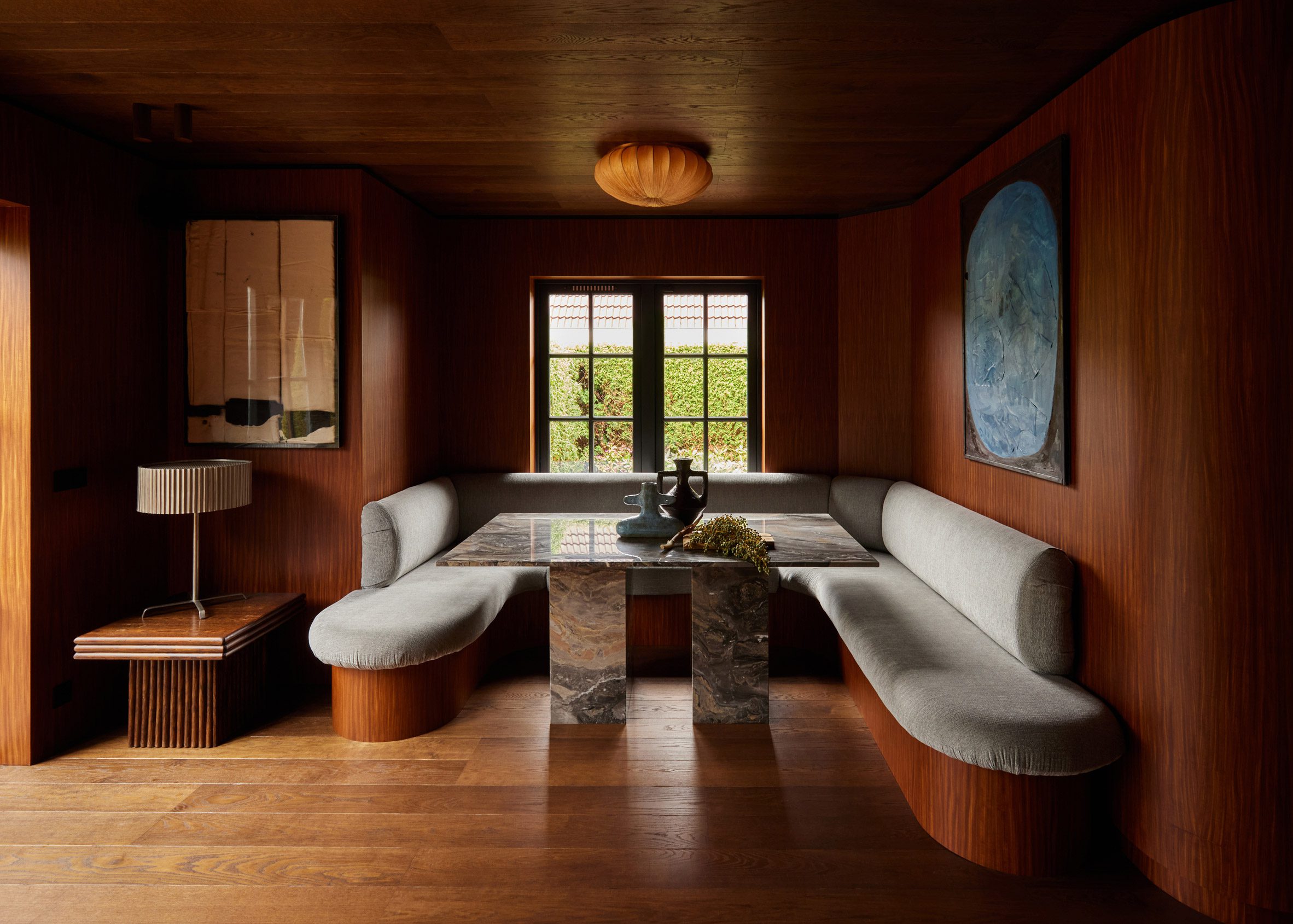 Wood-lined dining room with a built-in seating nook